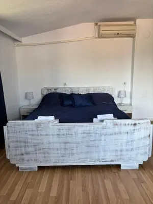 a bedroom with a bed with a plaid mattress at Apartment Park View in Sandanski