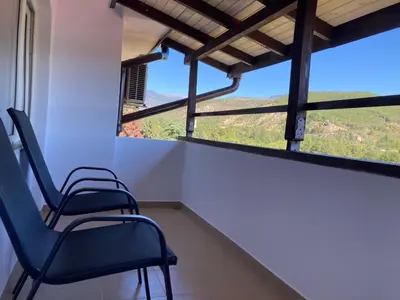 two chairs in a room with a large window at Apartment Park View in Sandanski