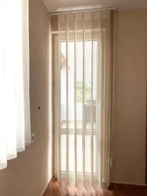 a room with a large glass door with a window at Apartment Park View in Sandanski