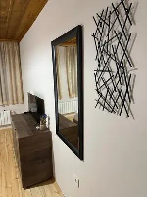 a mirror on the wall of a living room at Комплекс БОЖИДАРИЦА in Progled