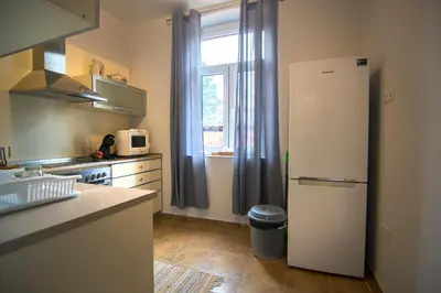a kitchen with a white refrigerator and a window at Tatyana City garden in Plovdiv