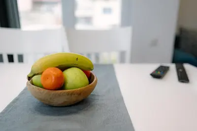 a wooden bowl of fruit sitting on a table at Top Center in Blagoevgrad