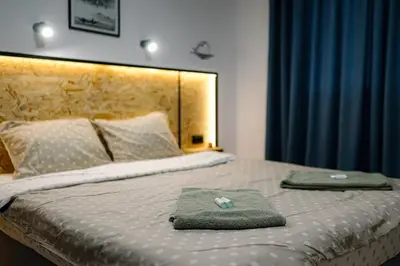 a bed with two towels sitting on top of it at Top Center in Blagoevgrad