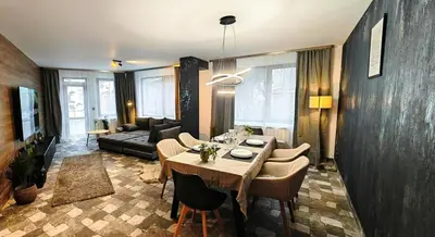 a living room with a table and a couch at Modern apartment with terrace in Chepelare
