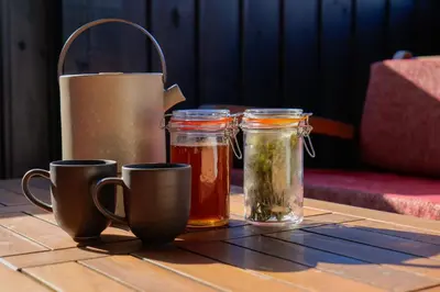 a table with three mason jars and a blender at Трите къщи in Leshten