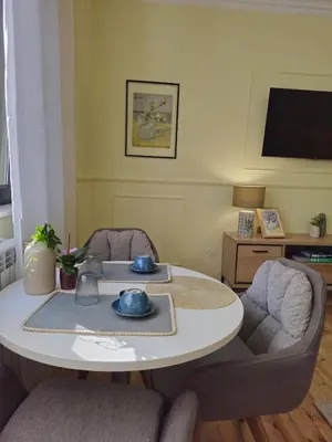 a living room with a table and two chairs at S íRMA Apartment - Next to the Old Cathedral in Sofia