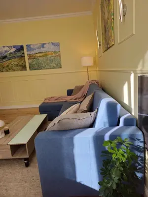 a living room with a blue couch and a table at S íRMA Apartment - Next to the Old Cathedral in Sofia