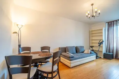 a living room with a table and a couch at Central Sofia Retreat in Sofia