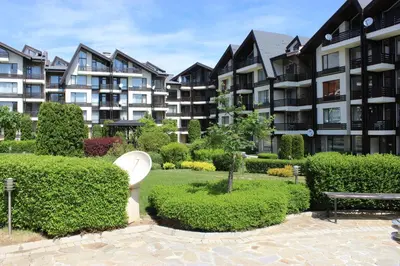 a toilet in a garden in front of some buildings at Apartment for guests in Bansko