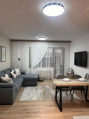 a living room with a couch and a table at Millennium apartment in Bansko