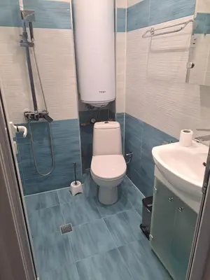 a small bathroom with a toilet and a sink at Удобство - 2 in Petrich