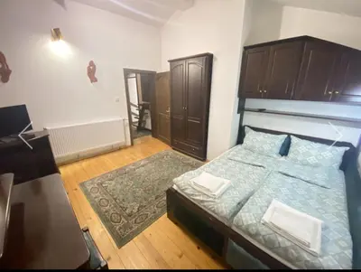 a bedroom with a bed and a wooden floor at Вила СевРич in Sarnitsa