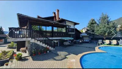 a large house with a swimming pool and a house at Вила СевРич in Sarnitsa