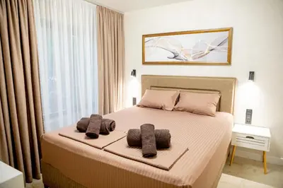 a bedroom with a bed with two towels on it at Apartments Polejanov in Razlog