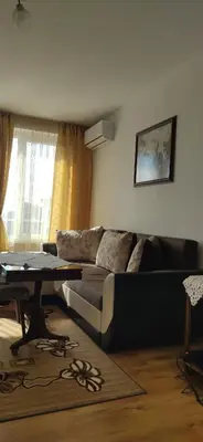 a living room with a couch and a table at Апартамент Калоян in Banya