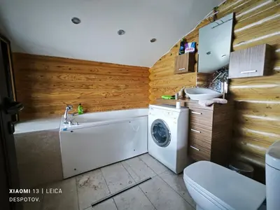 a bathroom with a washing machine and a sink at Стилни и Луксозни Вили за разпускане in Malo Buchino