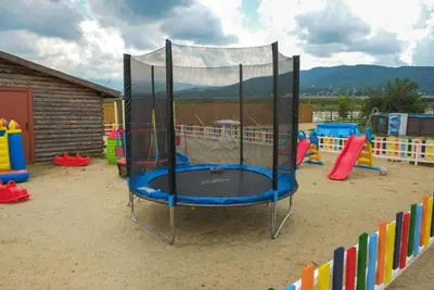 a playground with a trampoline in the middle at Стилни и Луксозни Вили за разпускане in Malo Buchino