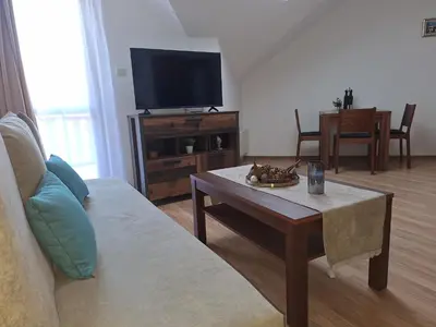 a living room with a couch and a coffee table at Rila Park by the Slopes in Borovets