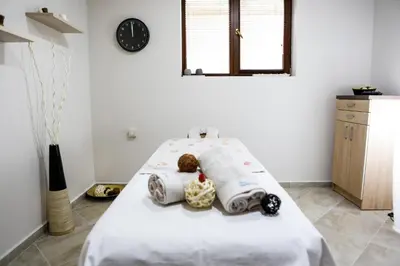 a bedroom with a bed with two teddy bears on it at Therma Vitae - Профилакториум Огняново in Ognyanovo