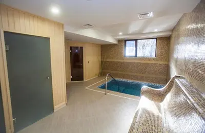 a room with a swimming pool in a building at Therma Vitae - Профилакториум Огняново in Ognyanovo