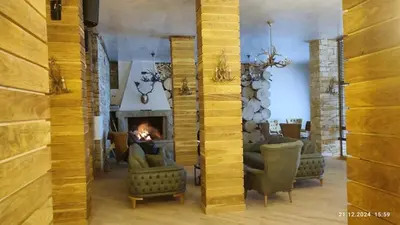 a living room with a fireplace and couches at Grand Studio A1 in Pamporovo