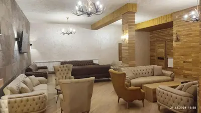 a living room with couches and tables and chairs at Grand Studio A1 in Pamporovo