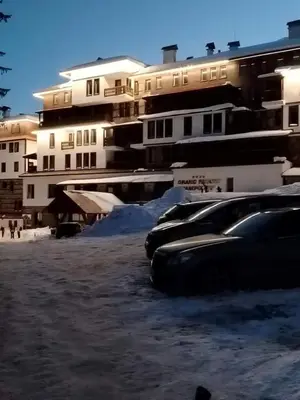 a row of parked cars in front of buildings at Grand Studio A1 in Pamporovo