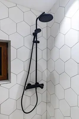 a shower in a bathroom with white tiles at Mountain studio Govedartsi in Govedartsi