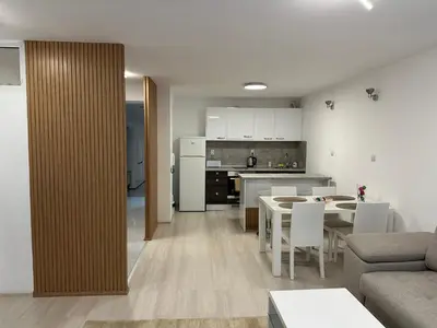 a living room and kitchen with a table and chairs at White Pearl Apartment - Top Location, Bright & Spacious, Newly Renovated in Sofia