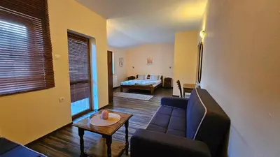 a living room with a couch and a table at Hotel Izvorat Arda - Хотел Изворът Арда in Arda