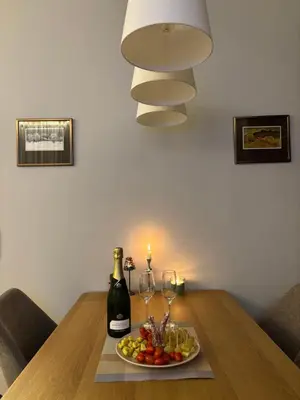 a table with a plate of food and a bottle of wine at Ski-in Flat Next to Ski Road at Mountain View in Bansko