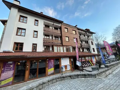 a building on a street in front at Ski-in Flat Next to Ski Road at Mountain View in Bansko