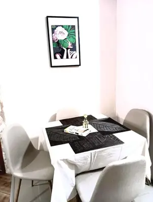 a dining room table with a black and white table cloth at Double to bul Tsar Boris 3 in Sofia