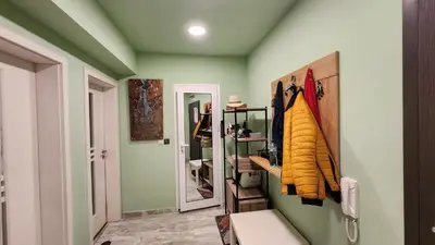 a room with a hallway with green walls and a mirror at Zen Lodge, with private parking next to Paradise in Sofia