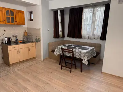 a kitchen with a table and a table and a kitchen sidx sidx sidx at Апартамент Лилия Сандански in Sandanski