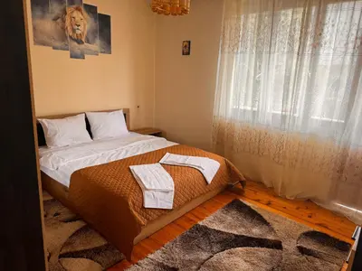 a bedroom with a bed with two towels on it at Апартамент Лилия Сандански in Sandanski