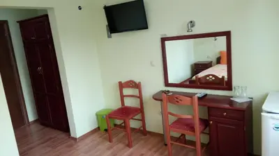 a room with a desk and a mirror and a bed at Motel Elegance in Sandanski