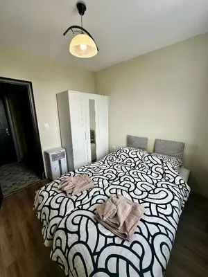 a bedroom with a bed with a black and white blanket at Maria Luiza 1 Bedroom Apartment in Sofia