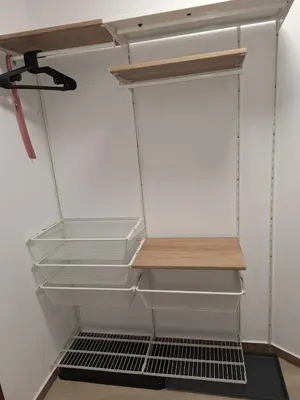 a closet with white shelves and a wooden shelf at Rila Park ap by the Slopes in Borovets