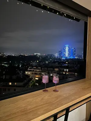 two wine glasses sitting on a ledge with a view at Blue Iris, 2BR, Stunning Views, Jacuzzi and Workspace in Sofia