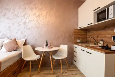 a small kitchen with a small table and chairs at DreamAparts in Velingrad