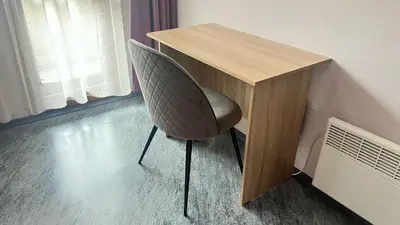 a chair sitting next to a desk in a room at Charming Urban Retreat in Sofia in Sofia