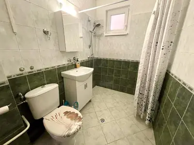 a bathroom with a toilet and a sink at Charming Urban Retreat in Sofia in Sofia