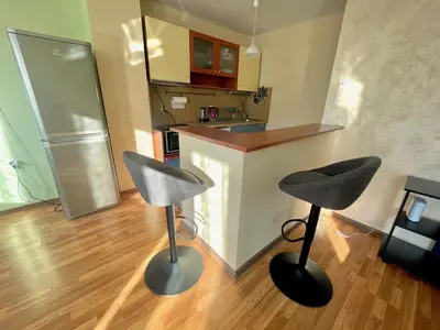 a kitchen with two stools in front of a counter at Charming Urban Retreat in Sofia in Sofia