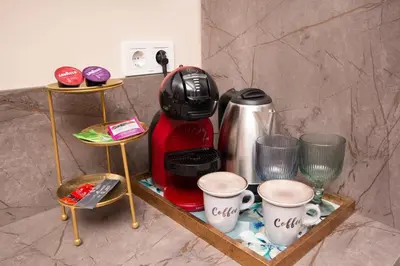 a shelf with a coffee maker and cups on it at Lambrina 2 Apartment in Plovdiv