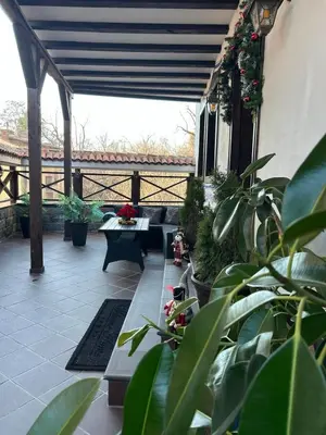 a patio with tables and potted plants on a building at Lambrina 2 Apartment in Plovdiv
