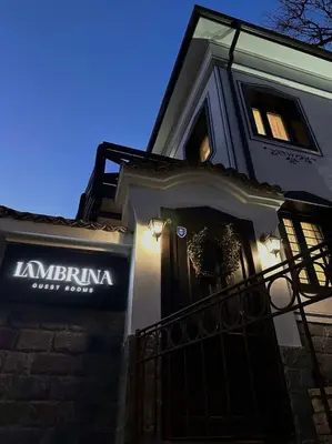 a building with a sign on the side of it at Lambrina 2 Apartment in Plovdiv