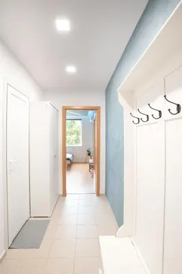 a hallway with white walls and a blue wall at Studio Sapphire in Sofia