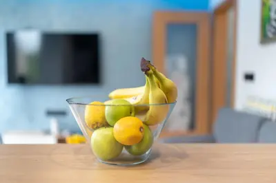a glass bowl filled with fruit on a table at Studio Sapphire in Sofia