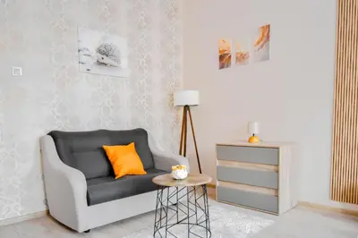 a living room with a chair and a table at Orchidea City Centre 1BDR by Flat Mаnager in Sofia